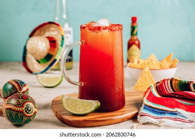 Michelada - Mexican inspired cocktail with beer, lime juice, tomato juice, spicy sauce and spices. Selective focus