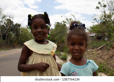 Miches, Dominican Republic, 16 april, 2019 / Local happy haitian or dominican kids playing on the side of the road, smiling