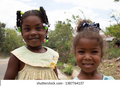 Miches, Dominican Republic, 16 april, 2019 / Local happy haitian or dominican kids playing on the side of the road, smiling