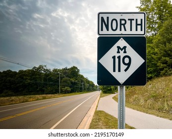 Michigan 119 North Road Sign. M-119 black and white informational interstate sign. M119 is also famously known as the scenic “Tunnel of Trees” in the Northern Michigan area. - Powered by Shutterstock