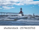 Michigan City Lighthouse on a summer day with high surf in Michigan City, Indiana USA 