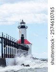 Michigan City Lighthouse on a summer day with high surf in Michigan City, Indiana USA 