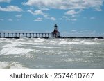 Michigan City Lighthouse on a summer day with high surf in Michigan City, Indiana USA 