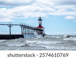 Michigan City Lighthouse on a summer day with high surf in Michigan City, Indiana USA 