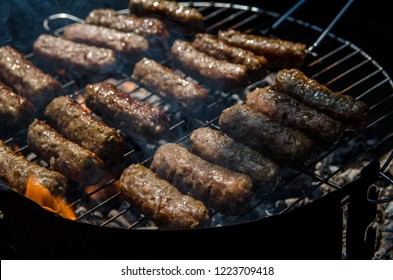 Mici, Mititei, small Romanian minced meatrolls, similar to serbian cevapi, fresh balkan skinless sausages, cooked outside on the barbecue
