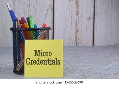 Micro Credentials Wording With Stationery Over A Blur Background. Selective Focus Image