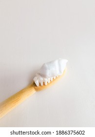 Micro Plastic Particles In A Smear Of Toothpaste On A Wooden Toothbrush. Representation Of The Micro Plastic Problem In Personal Care Products That Damage Nature.