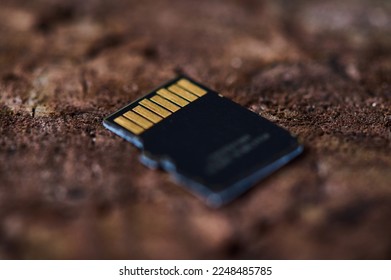 micro sd memory card on a wooden background extreme close-up