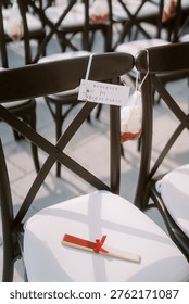 Micro Wedding Setup Featuring Black Chairs And White Cushions