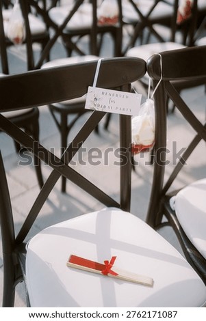 Micro Wedding Setup Featuring Black Chairs And White Cushions