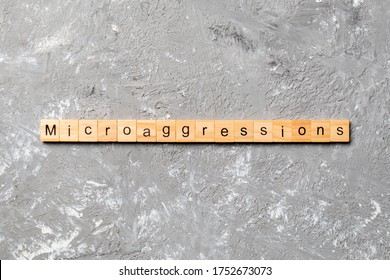 Microaggressions word written on wood block. Microaggressions text on cement table for your desing, concept. - Shutterstock ID 1752673073