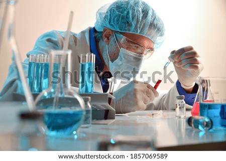 Microbiologist mixing reagent with sample in laboratory. Horizontal composition. Front view.