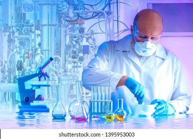 Microbiology laboratory. Man chemist rubs in a mortar reagents. Synthesis of microorganisms in the bioreactor. Production of biofertilizers. The cultivation of biomass. Laboratory equipment. - Powered by Shutterstock