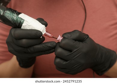 Microblading artist in a black gloves mixing pigment in ink ring cup. Close-up of pigment ring container and ink for eyebrow tattoo. Beauty procedure preparation.	 - Powered by Shutterstock