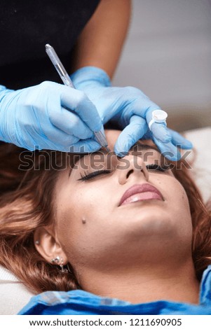 microblading close up, eyebrow adding pigment into skin.