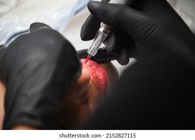 Microblading process, Permanent makeup on woman's lips with tattoo pen machine