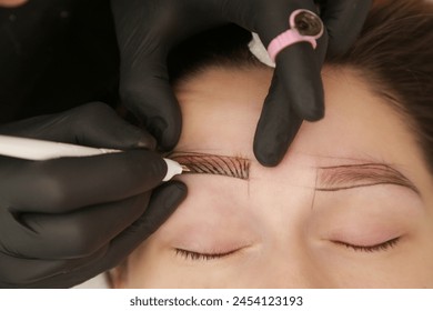 Microblading - semi-permanent tattooing technique used for the eyebrows by creating an illusion of a more defined and fuller brow. Artist makes tiny hair-like strokes to create a natural looking brows - Powered by Shutterstock