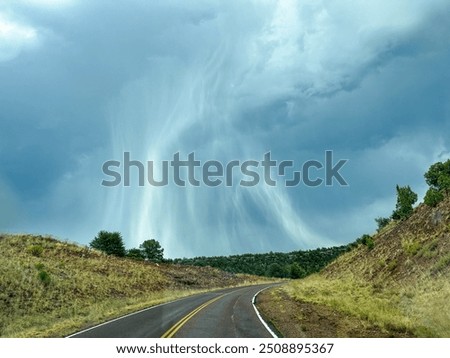 Microburst grey rain cloud driving home