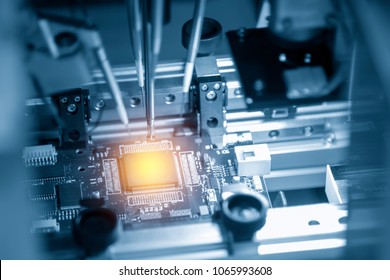 The Microchip On The Main Board In The Assembly Line In The Light Blue Scene With Lighting Effect, Computer Part Manufacturing Concept.