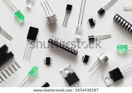 Microcontrollers, transistors, green LEDs, microcircuits, thyristors on a white background. Radio Components