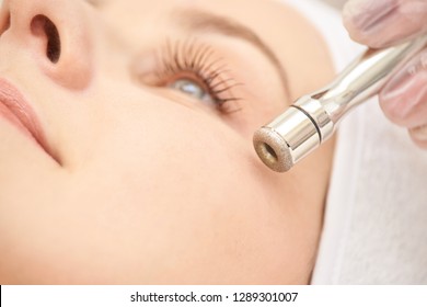 Microdermabrasion clinic treatment. Aesthetic facial procedure. Diamond face clean. Medicine beauty anti acne and hyperpigmentation cosmetic. Cosmetologist hand.