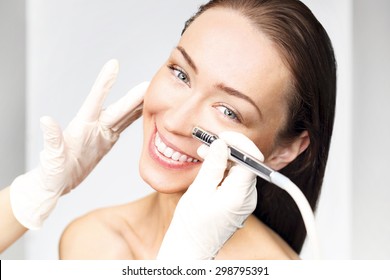 Microdermabrasion. Woman during a microdermabrasion treatment in beauty salon