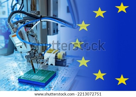 Microelectronics production in European Union. PCB making machine. Microelectronics in Europe. Automated soldering machine for microelectronics. PCB manufacture in European Union. EU flag. 