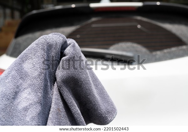 microfiber cloth with hand preparing to\
wash a car. Car wash concept. Selective\
focus.