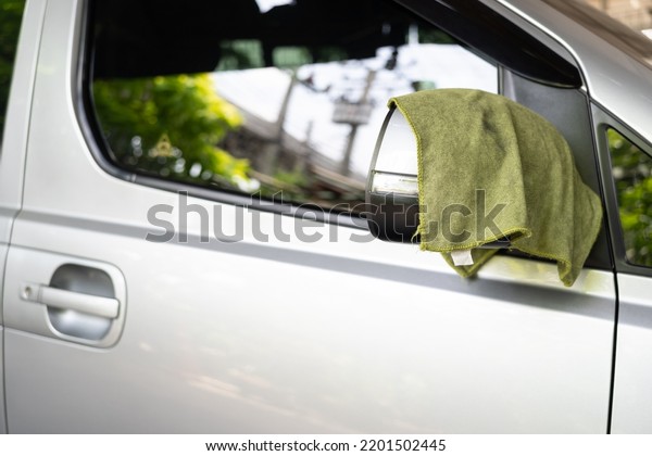 microfiber cloth with hand preparing to\
wash a car. Car wash concept. Selective\
focus.