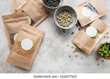 Microgreen seeds in paper bags and microgreen sowing equipment on the table. Healthy food.