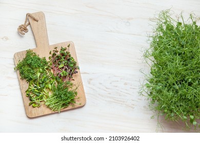 Microgreens growing on the wooden table. Top view. - Shutterstock ID 2103926402