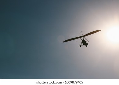 A microlight aircraft flying in the sky.
