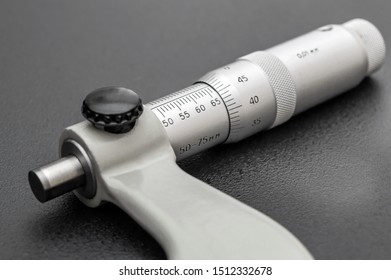 Micrometer on black background. Close up.