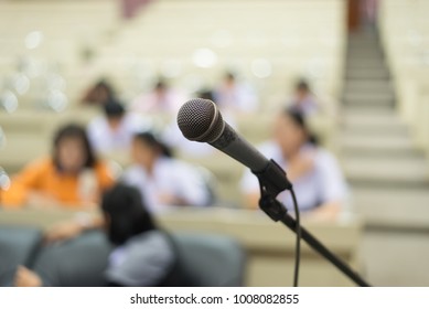 Microphone in the auditorium with blurred background of people