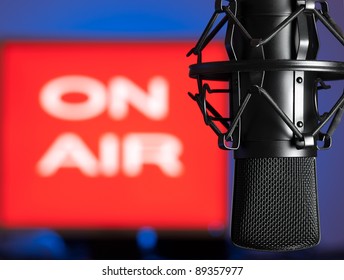 Microphone with blurred on  air sign in the background, for broadcasting,sound related themes