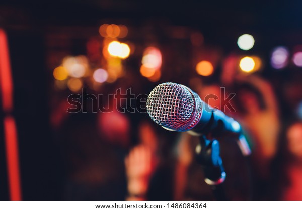 Microphone. Microphone close-up. A pub. Bar. A\
restaurant. Classical music.\
Music.