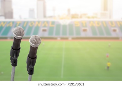 Microphone For Commentator With Sport Football Field Stadium Background With Space For Text