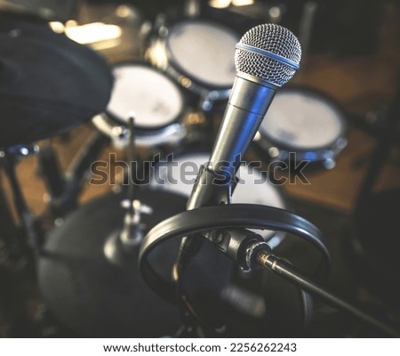 Microphone and drums in recording studio for live music perfomance closeup. Mic stage for rock and pop vocal presentation