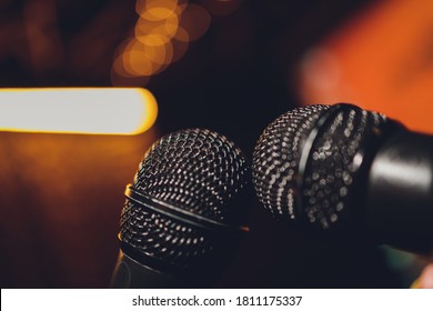 Microphone And Female Singer Close Up. Woman Singing Into A Microphone, Holding Mic With Hands.