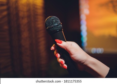 Microphone And Female Singer Close Up. Woman Singing Into A Microphone, Holding Mic With Hands.