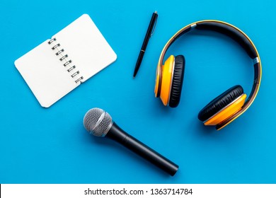 microphone, headphones, notebook for blogger, journalist or musician work on blue background top view mockup - Shutterstock ID 1363714784