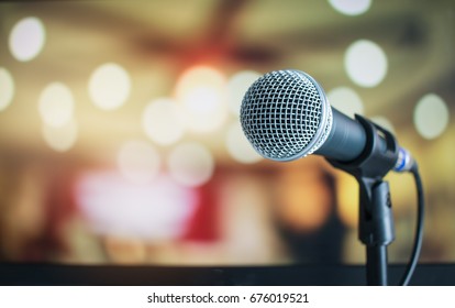 Microphone on abstract blurred of speech in seminar room or speaking conference hall light, Event Background - Shutterstock ID 676019521