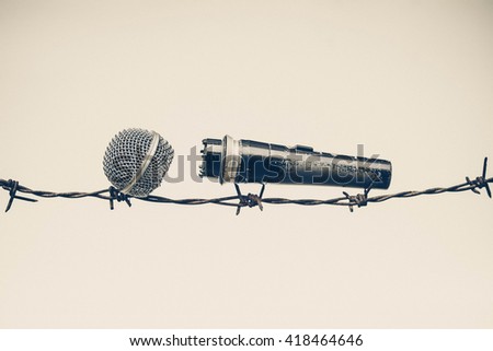 A microphone on a barbed wire - Freedom of the press is at risk concept