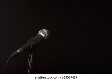 Microphone on empty black background