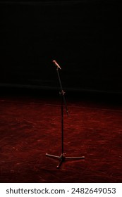 Microphone on an empty stage: mic and mic stand.