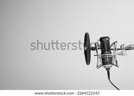 a microphone on gray background with copy space. podcasting background. 