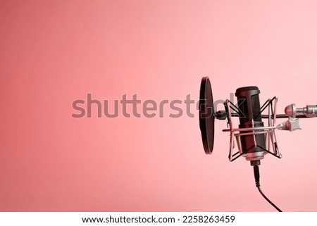 microphone on pink background with copy space for recording ,singing, podcasting concept. 
