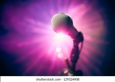 Microphone On Stage Against Purple Rays