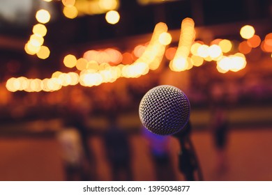 Microphone On A Stand Up Comedy Stage With Colorful Bokeh , High Contrast Image.