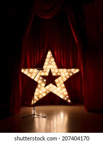 Microphone On Theater Stage,golden Star  With Red Curtains Around